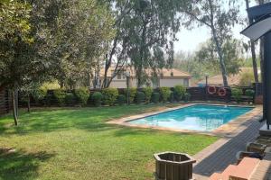 a yard with a swimming pool in a yard at Home Away From Home in Midrand