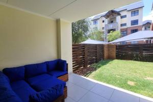 a living room with a couch and a view of a yard at Home Away From Home in Midrand