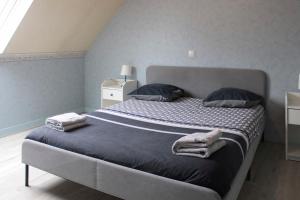 a bedroom with a large bed with towels on it at Cozy and spacious house in Saint-Denis in Saint-Denis