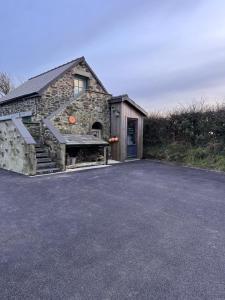 a stone building with a large letter k on it at Cwtch Lackerlee in Haverfordwest