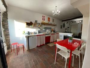cocina con mesa roja y sillas en Vezzhouse con Convenzione per Spa & Wellness, en Vezzano Ligure