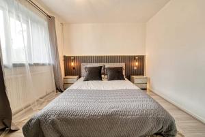a bedroom with a large bed and a large window at Stylish 1BR Apartment - Parking - Netflix in Walsall