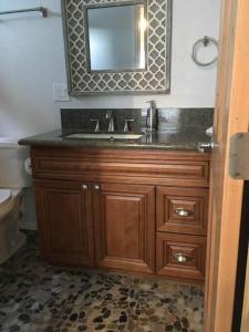 a bathroom with a sink and a mirror at Pelican Place in Morro Bay in Morro Bay