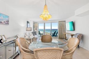 a dining room with a glass table and chairs at Beachside Two 4278 in Destin