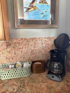 a counter top with a coffee maker and a blender at Pelican Place in Morro Bay in Morro Bay