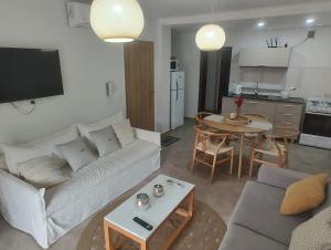 a living room with a white couch and a table at Departamento por día Junín Centro in Junín