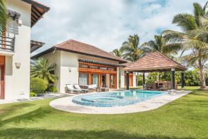 a house with a swimming pool in a yard at Amazing 5br villa w pool at Green Village A in Punta Cana