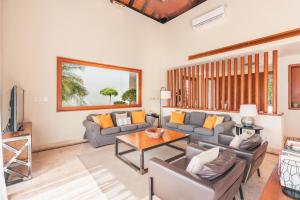 a living room with a couch and a table at Amazing 5br villa w pool at Green Village A in Punta Cana