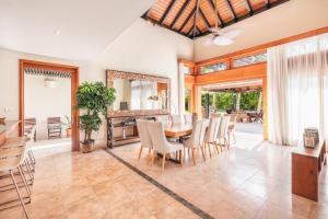 a dining room with a table and chairs at Amazing 5br villa w pool at Green Village A in Punta Cana