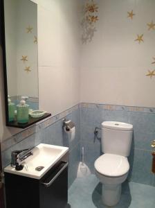 a bathroom with a white toilet and a sink at HOLYDAY HOME SUANCES in Suances