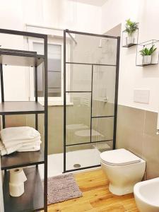a bathroom with a glass shower and a toilet at Brand New Panoramic Apartment in Vitinia