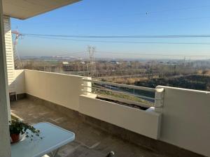 a balcony with a table and a view at Brand New Panoramic Apartment in Vitinia