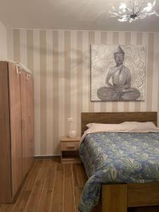 a bedroom with a bed and a painting on the wall at Brand New Panoramic Apartment in Vitinia