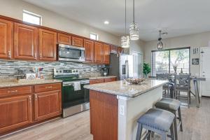 a large kitchen with wooden cabinets and a kitchen island at Family-Friendly Phoenix Home 5 Mi to Westgate! in Phoenix