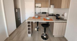 a kitchen with a counter with two cups on it at Departamento ejecutivo in Antofagasta
