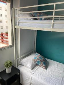 a bedroom with bunk beds with a pillow and a table at Apartamento de 3 hab en Costa Adeje centro in Adeje