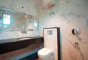 a bathroom with a toilet and a sink at Bonito Rooms- Home Stay in Ecotech-III in Greater Noida
