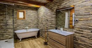 a bathroom with a bath tub and a sink at Quinta Alvaredo in Melgaço +21 photos