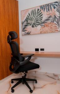 a black office chair sitting in a room at Hotels 111 in San Andrés
