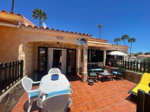 a patio with a table and chairs on a house at Santa Fe Bunglow Deluxe Playa Del Ingles in Maspalomas