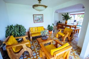 sala de estar con sillas amarillas y mesa en FINCA VILLA ESMERALDA en Pereira