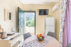 a dining room with a table with a bowl of fruit on it at Amazing Sea View Balcony Ginos Home 123 in Glyfada