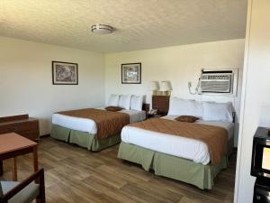 a hotel room with two beds and a table at Royal Inn in Albany