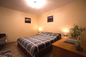 a bedroom with a bed and a table in it at Nadezhda Apartments at Kabanbay Batyr 79 in Almaty