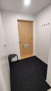 an empty room with a door and a chair at Lovely new studio for 3 - close to airport, free parking in Vantaa
