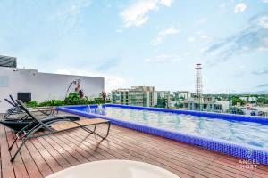 a swimming pool on the roof of a building at Condo with Amenities Sleeps 8 Roof Pool Gym in Playa del Carmen +23 photos