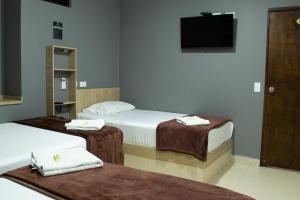 Voodi või voodid majutusasutuse Hotel Ruiseñor Itagui toas