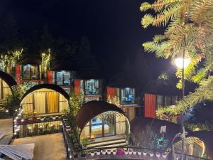 a large building with a lot of windows at night at Plum Homestay in Dồng Văn