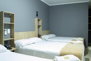 Voodi või voodid majutusasutuse Hotel Ruiseñor Itagui toas