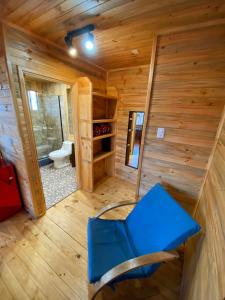 a blue chair in a room with a toilet at Lilafken Apart Pichilemu in Pichilemu +151 photos