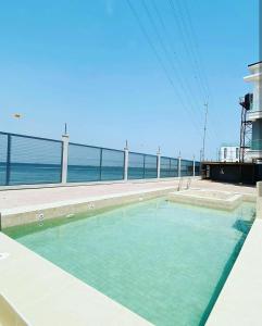 a swimming pool with a view of the ocean at Stylish Modern Studio Apartment Banana Island Ikoyi in Lagos