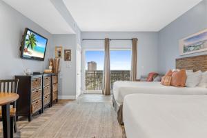 a hotel room with two beds and a balcony at Luau II 7026 Studio in Destin
