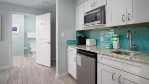 a kitchen with a sink and a microwave at Luau II 7226 Studio in Destin