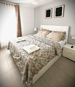 a bedroom with a bed with two towels on it at Sun Apartment Cristimar (3 bedrooms) in Los Cristianos