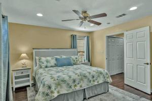 a bedroom with a bed and a ceiling fan at Cast-A-Waves in Port Aransas +22 photos
