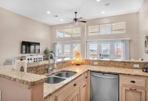 a kitchen with a sink and a dishwasher at Cast-A-Waves in Port Aransas