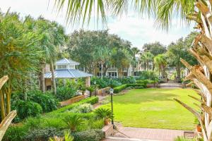 an exterior view of a garden with palm trees at Pilot House 412 in Destin