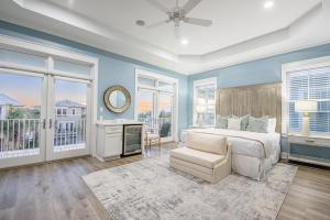 a bedroom with blue walls and a bed and a chair at Slice of Paradise in Destin