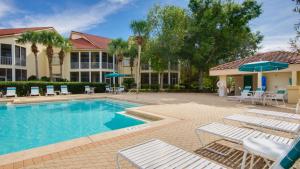 a swimming pool with lounge chairs and a resort at Tivoli 5258 in Destin