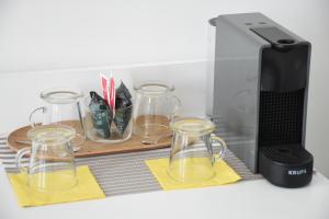 a counter with four glass jars and a blender at Bed-da Catania Rooms in Catania