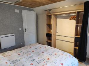 a bedroom with a bed and a closet at le nid du calice in Abreschviller