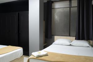 Voodi või voodid majutusasutuse Hotel Ruiseñor Itagui toas