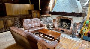 a living room with a couch and a fireplace at O!Bora in Neple