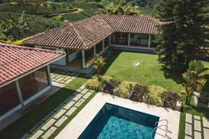 an aerial view of a house with a swimming pool at The Coffee Club Campestre in Chinchiná