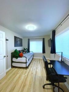 a bedroom with a bed and a desk and a window at *NEW* The Cozy Haven, 5 minutes to ATL airport in Atlanta