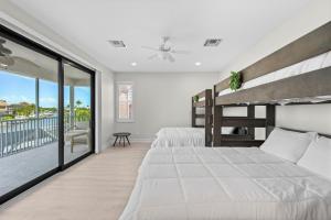 a bedroom with two beds and a balcony at Sweet Waterfront Retreat in Marco Island +25 photos